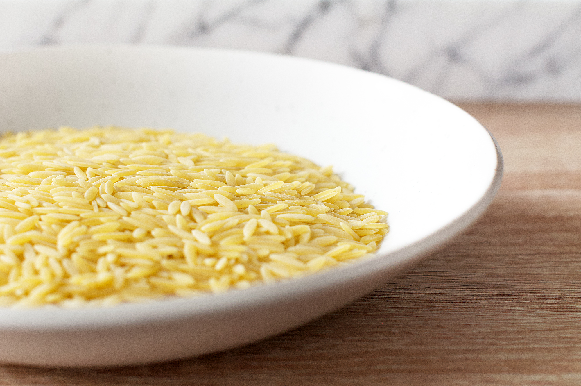 Uncooked rice-shaped orzo pasta, risoni pasta, puntalette pasta